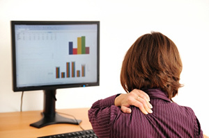 Osteochondroza szyjki macicy u kobiety siedzącej przy komputerze